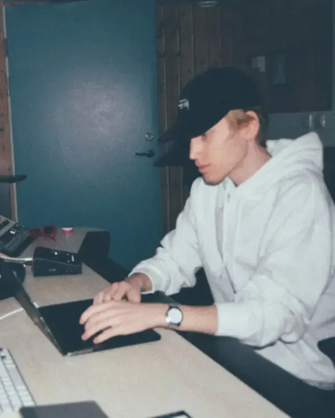 Anton Hansson sitting in front of a laptop inside of a music studio